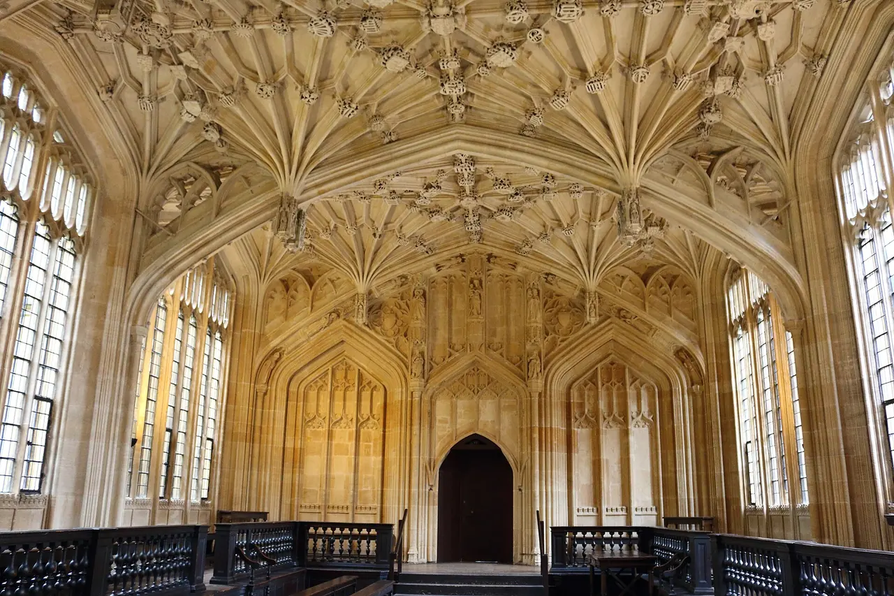 The far end of the Divinity School, its carved stone vault above dark wooden benches