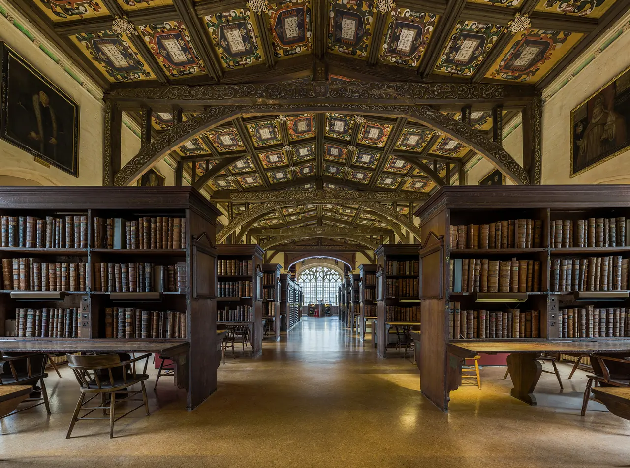Duke Humfrey's Library, oak bookcases beneath a painted ceiling, looking along the reading room